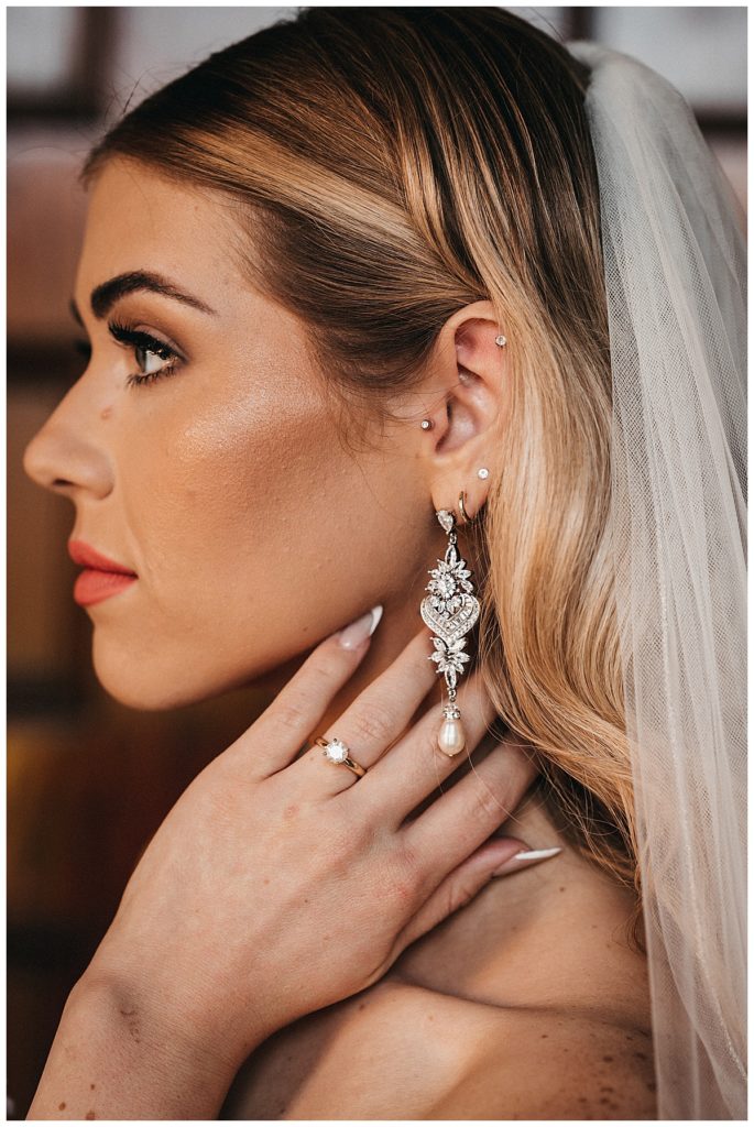 Wedding ring and long earring on new bride at Rice University Wedding 