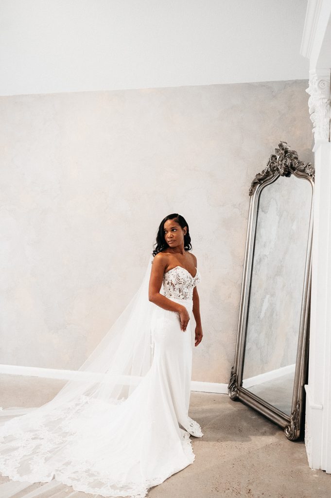 Bride posing in front of full length mirror at The Oak Atelier. 