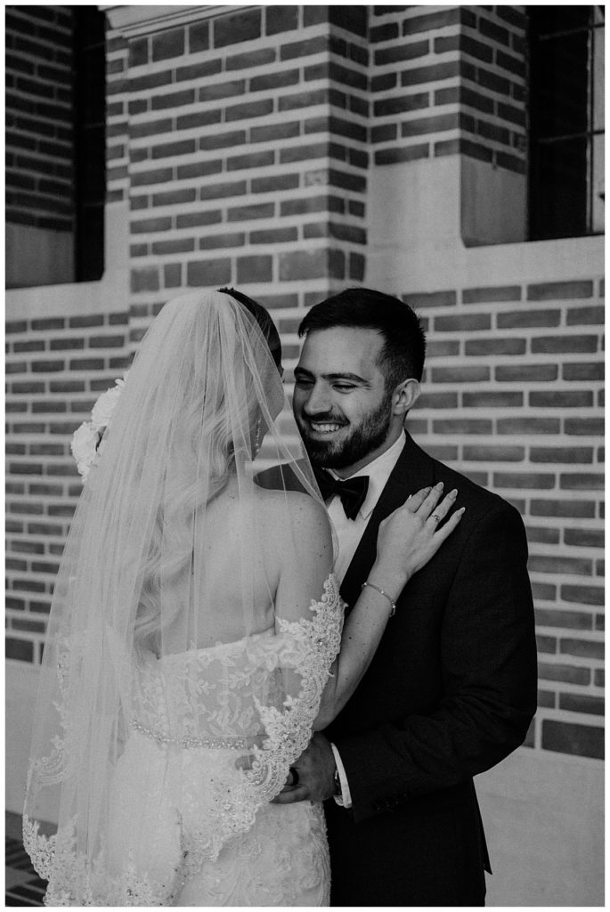 Bride and groom laughing and embracing at their couples portraits by Houston Wedding Photographer, Brittany Emanuel. 