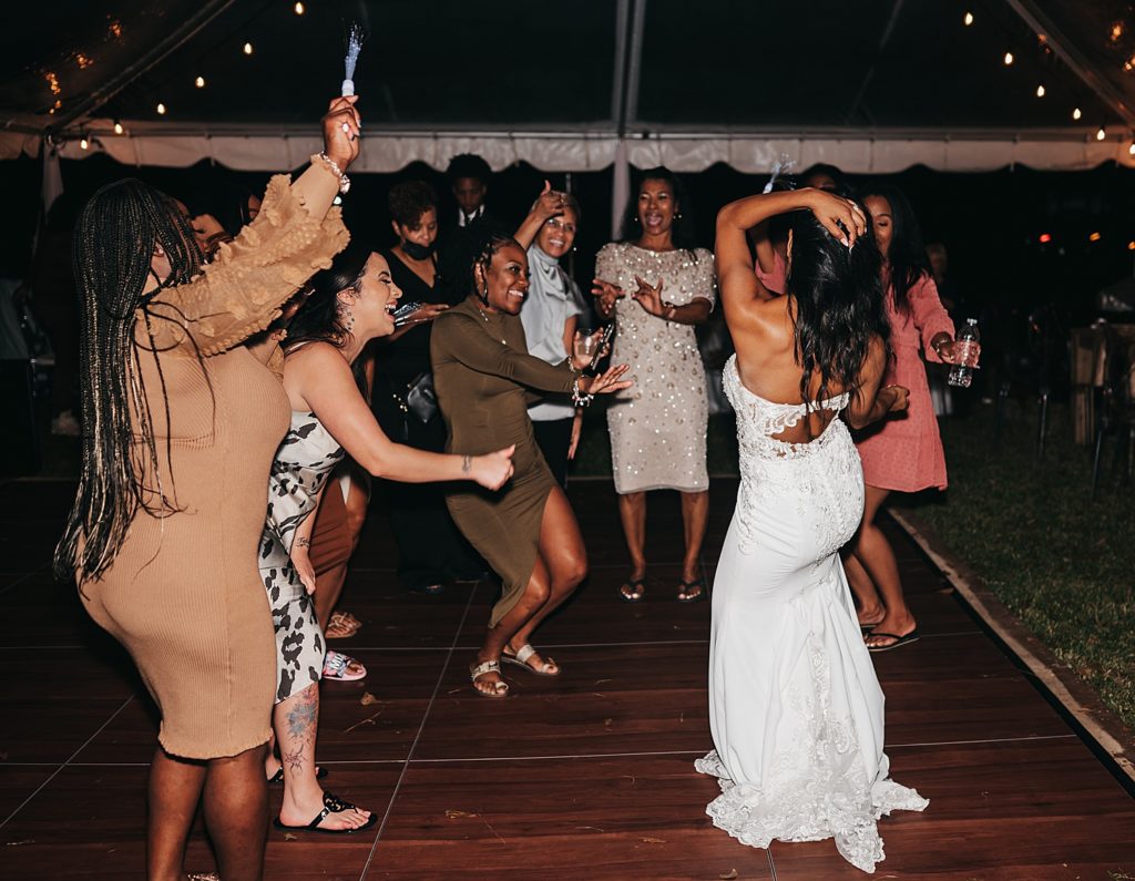Bride dancing with guests at her Houston reception. 