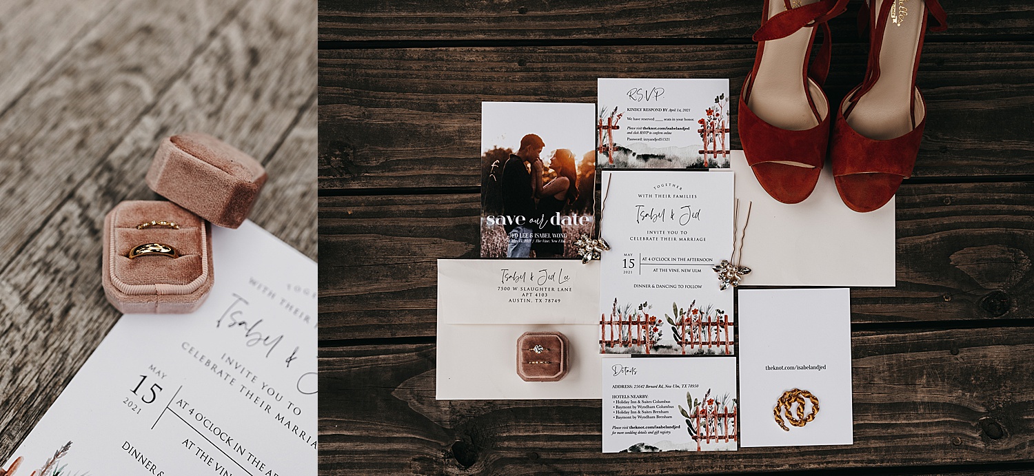 Wedding invitations laying flat on venues floor with wedding bands.
