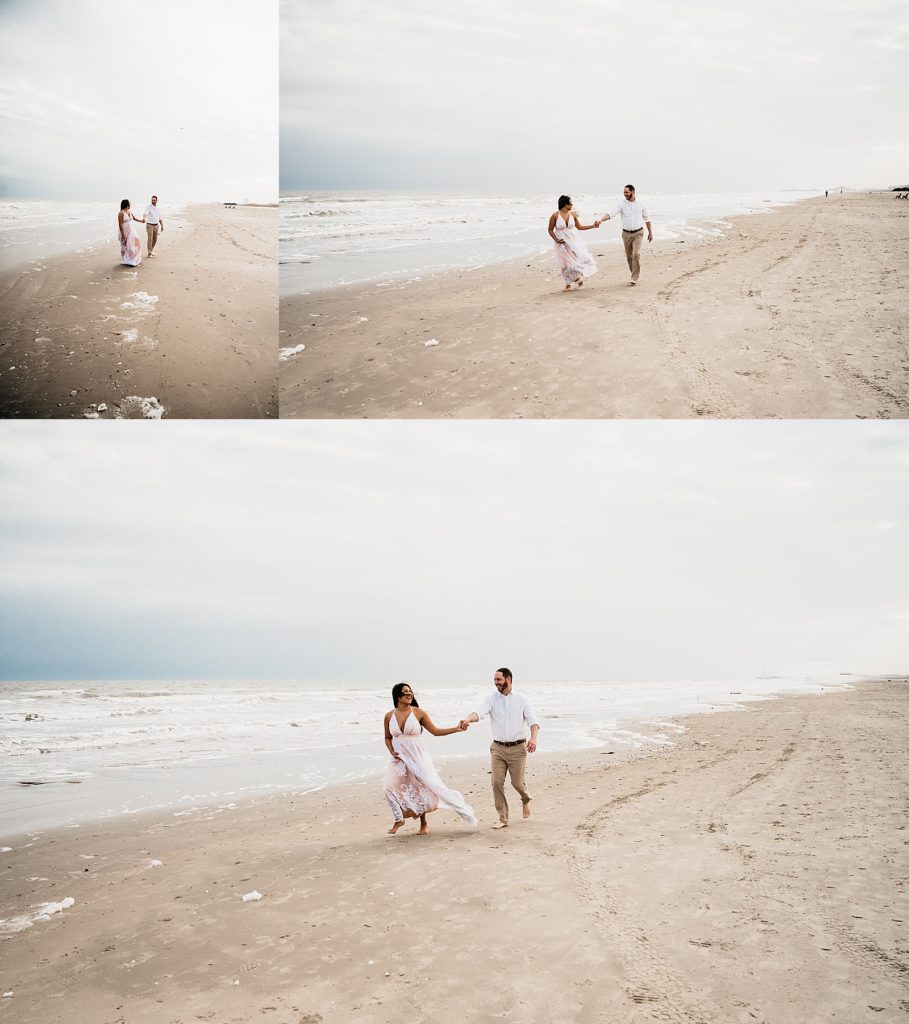 Woman in long dress and man in white button down running along the beach in Galveston, Texas.