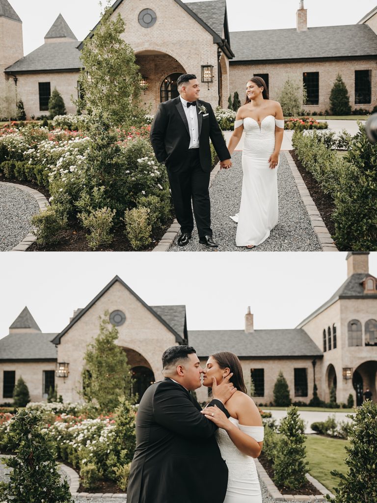 Bride in off the shoulder lace dress and groom in a black tux walking through a garden after their Houston wedding.