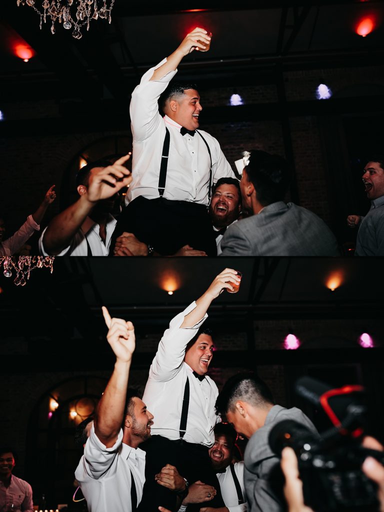 Groom being lifted on the shoulders of his friends in celebration at this elegant & neutral Houston wedding. 