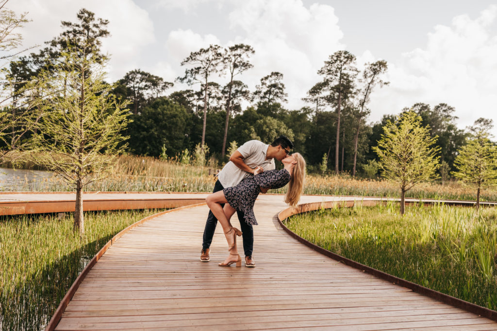 Couple dip kiss along on a path at Memorial Park - Engagement Session Locations