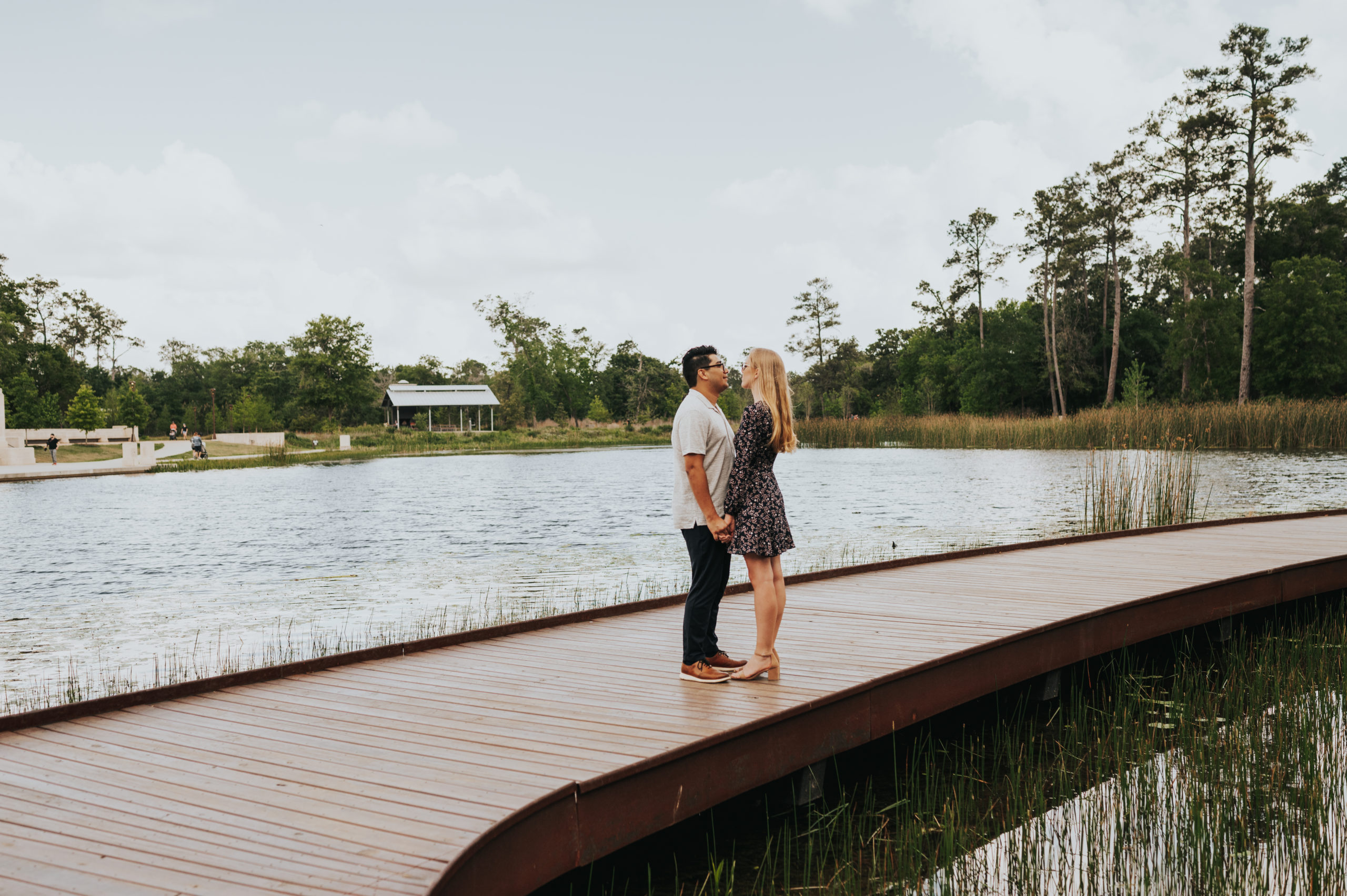 couple holding hands on a bridge during their engagement session