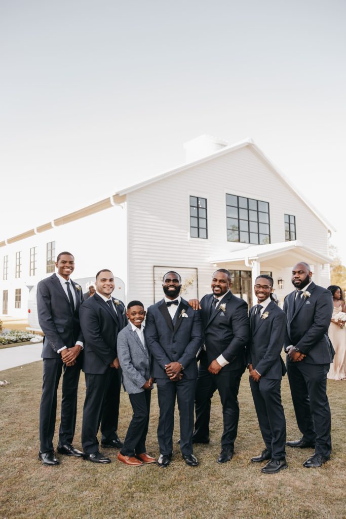 Groom and groomsmen stand for portraits