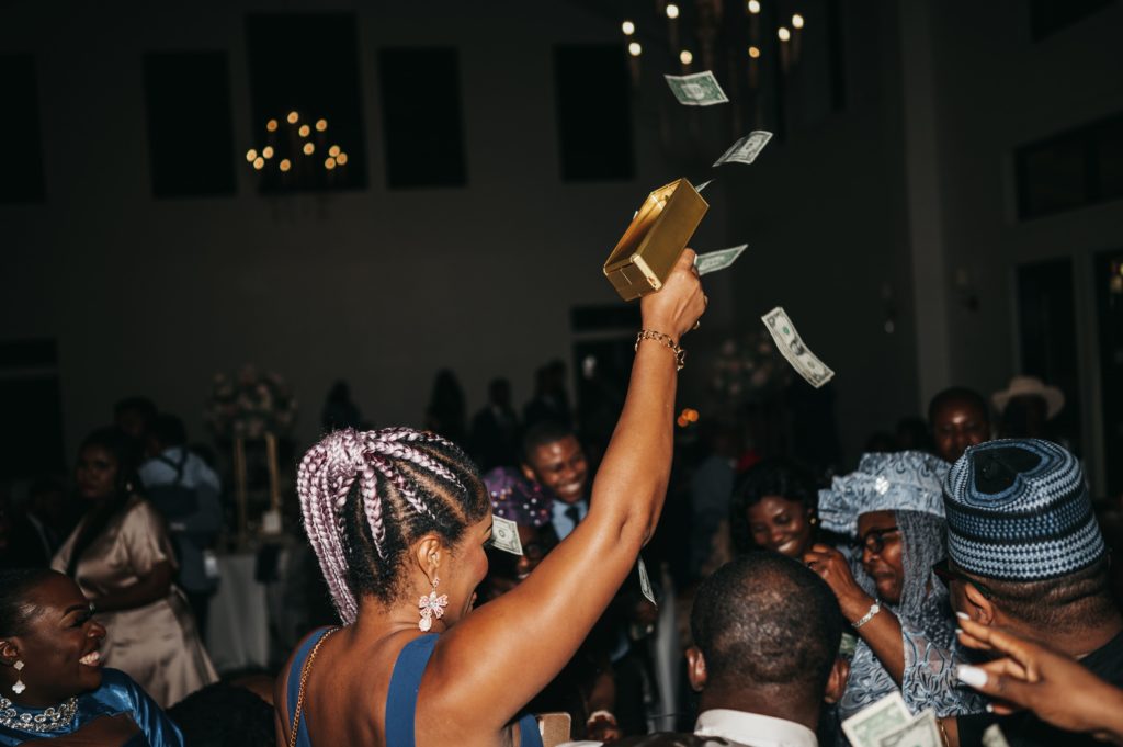 Woman holding cash cannon for Nigerian money spray